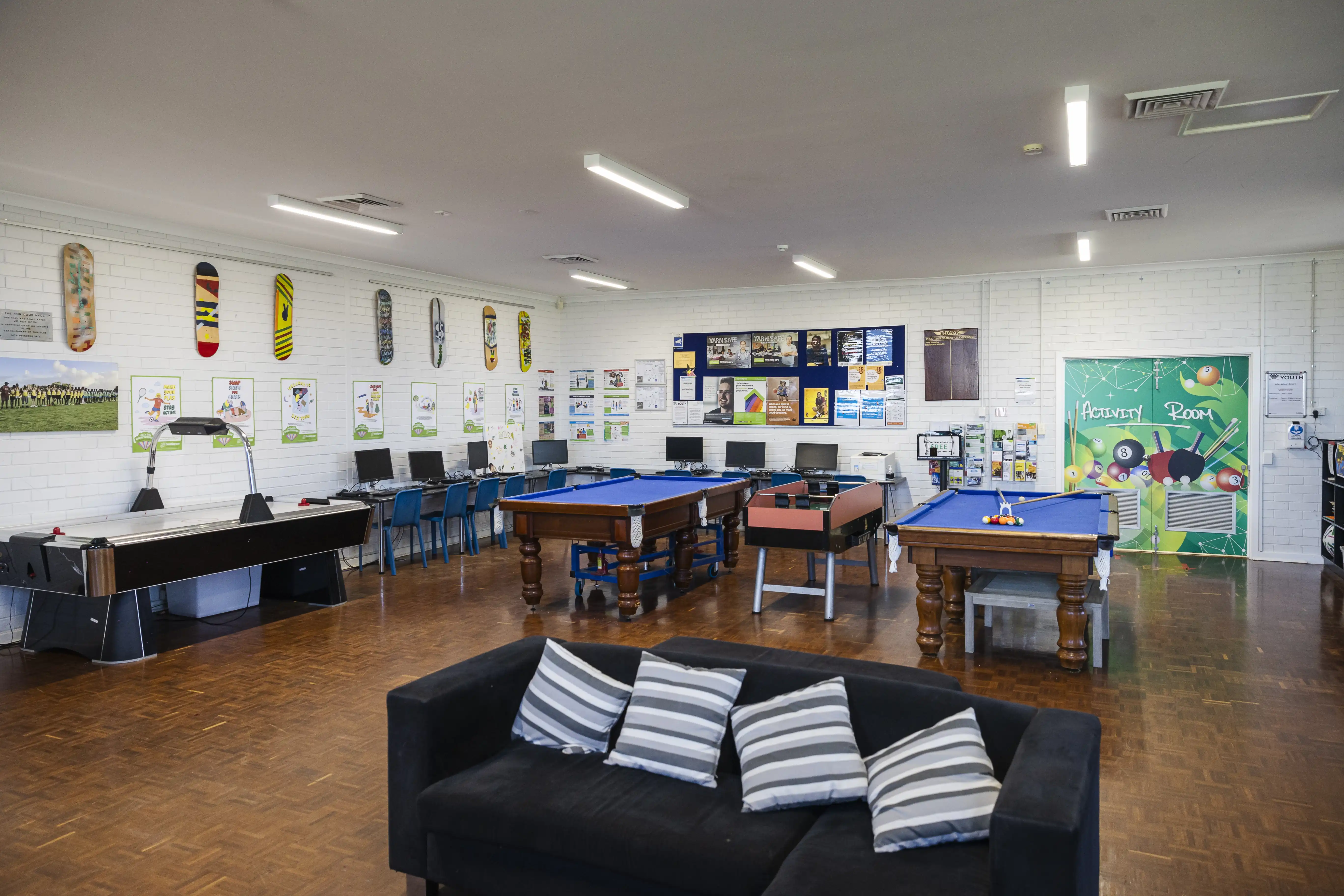 Interior of Billy Dower Youth Centre with sofa, pool tables, computers. 